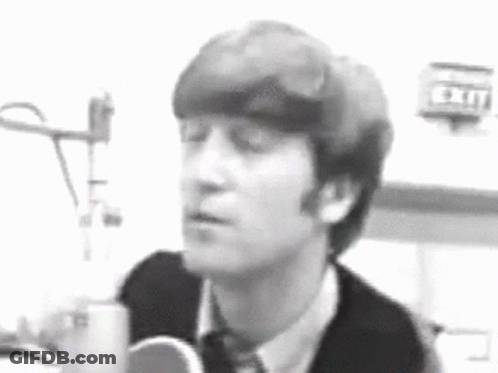 Black And White John Lennon Singing Into Microphone GIF