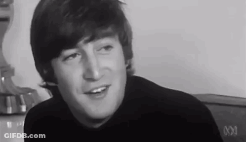Black And White John Lennon Smiling And Talking GIF