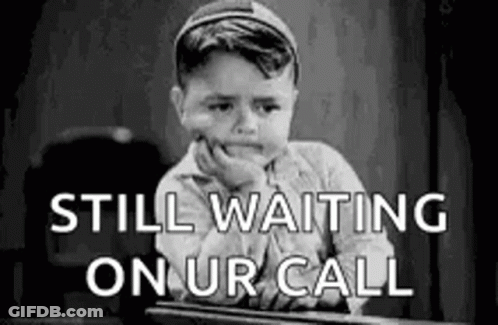 Black And White Little Boy Waiting For Call At Desk GIF