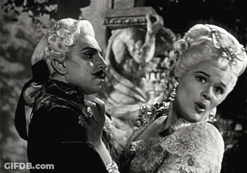 Black And White Man And Woman In Costumes GIF