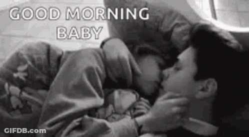 Black And White Man And Woman Kissing In Bed GIF
