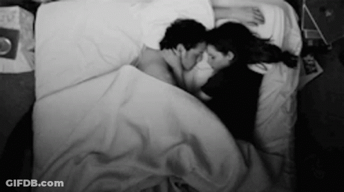 Black And White Man And Woman Lying In Bed GIF