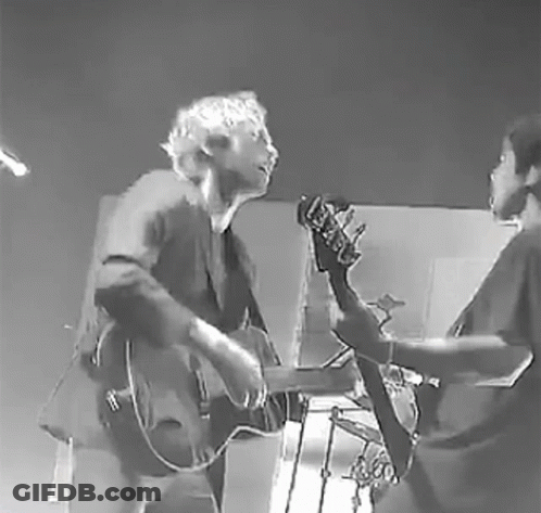Black And White Man And Woman Playing Guitar And Bass GIF