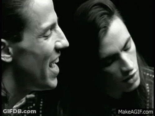 Black And White Man And Woman Singing GIF