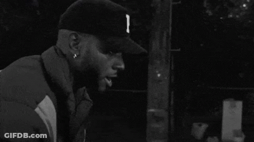 Black And White Man In Baseball Cap And Jacket GIF