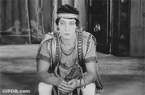 Black And White Man In Costume Sitting GIF