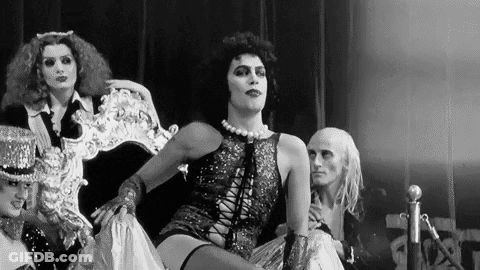 Black And White Man In Costume Sitting On Chair GIF