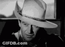 Black And White Man In Cowboy Hat And Scarf GIF