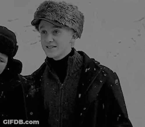 Black And White Man In Fur Hat With Woman In Snow GIF