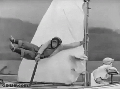Black And White Man In Helmet On Sailboat GIF