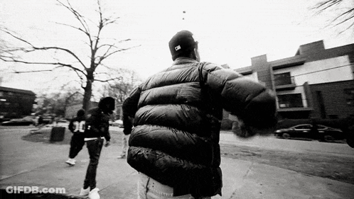 Black And White Man In Jacket Hat Walking GIF
