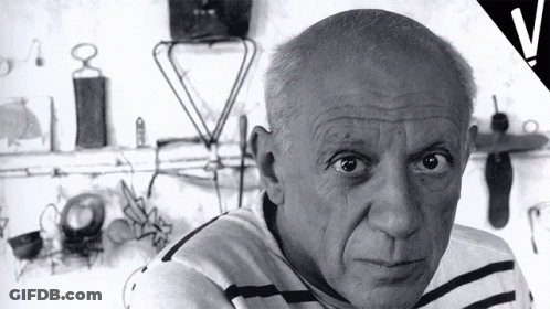Black And White Man In Striped Shirt Looking At Camera GIF