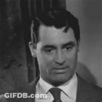 Black And White Man In Suit And Tie Looking At Camera GIF