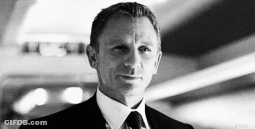 Black And White Man In Suit And Tie Looking At Camera GIF