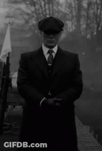 Black And White Man In Suit Holding Gun GIF