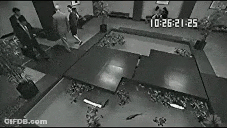 Black And White Man In Suit On Stage GIF