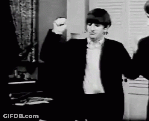 Black And White Man In Suit Raising Fist GIF