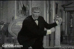 Black And White Man In Tuxedo Holding Statue GIF