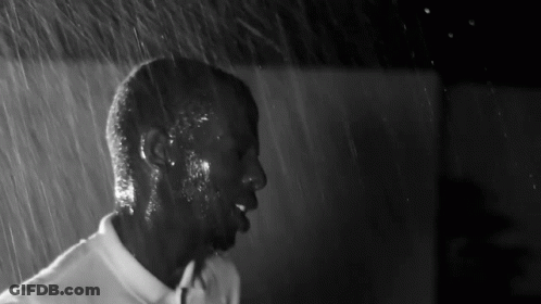 Black And White Man In White Shirt In Rain GIF