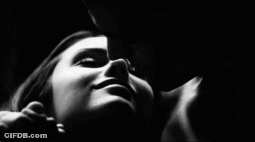 Black And White Man Kissing Woman On Cheek GIF