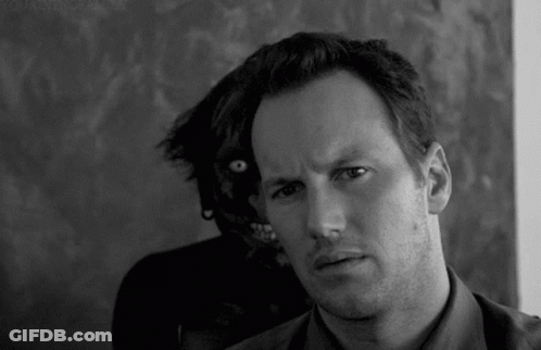 Black And White Man Looking At Camera With Monster Behind GIF