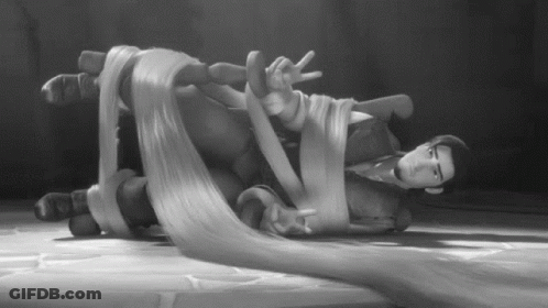 Black And White Man Lying On Floor With Hair Tied Up GIF