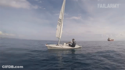 Black And White Man On Pier Next To Sailboat GIF