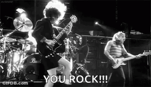 Black And White Man Playing Guitar On Stage Saying You Rock GIF