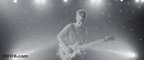 Black And White Man Playing Guitar On Stage GIF
