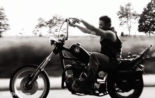 Black And White Man Riding Motorcycle With SS Logo GIF