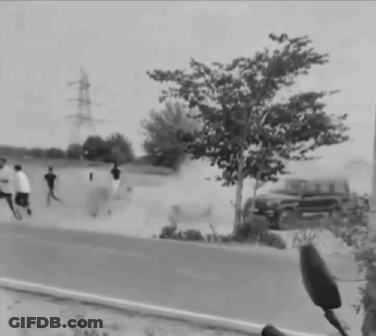 Black And White Man Running Towards Car On Road GIF