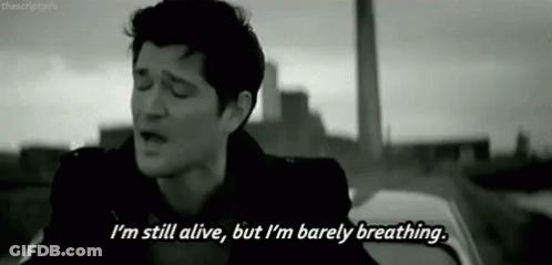 Black And White Man Singing I'm Still Alive But I'm Barely Breathing GIF