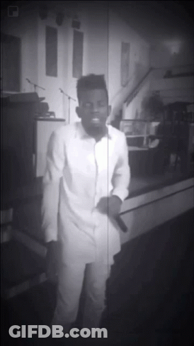 Black And White Man Singing Into Microphone In Church GIF