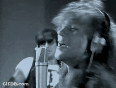 Black And White Man Singing Into Microphone In Recording Studio GIF