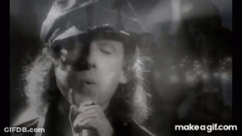 Black And White Man Singing Into Microphone Smoking GIF