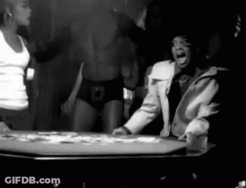 Black And White Man Sitting At Table With Cards GIF