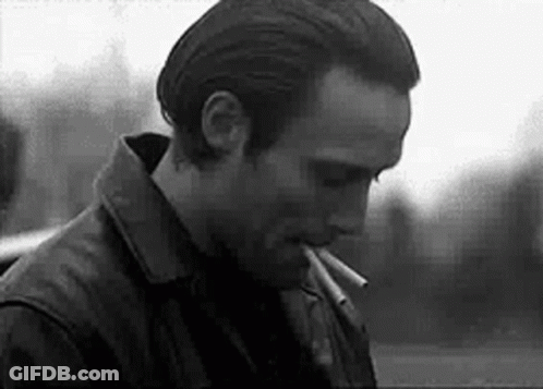 Black And White Man Smoking Cigarette In Leather Jacket GIF