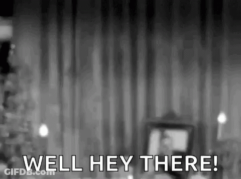 Black And White Man Standing At Curtain GIF