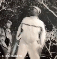 Black And White Man Standing By Tree GIF