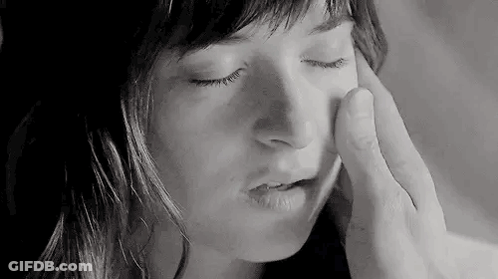 Black And White Man Touching Woman's Face With Finger GIF