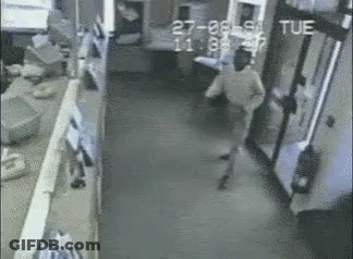 Black And White Man Walking Down Hallway With Tue GIF