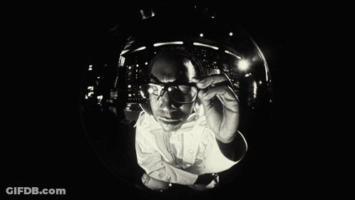 Black And White Man With Glasses Looking Down GIF
