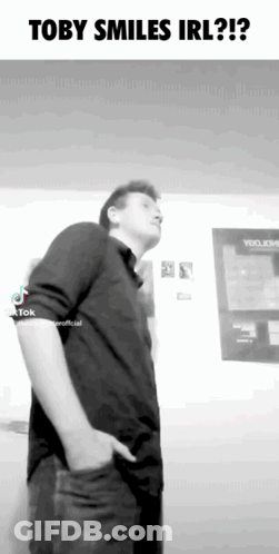 Black And White Man With Hands In Pockets Toby Smiles Irl GIF