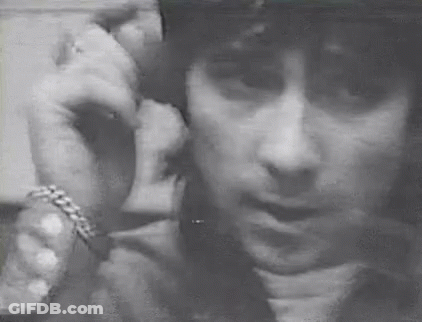 Black And White Man With Helmet On Phone GIF