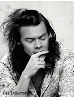 Black And White Man With Long Hair Hand To Mouth GIF