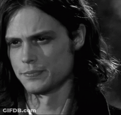 Black And White Man With Long Hair Looking At Camera GIF