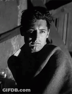 Black And White Man Wrapped In Blanket Smoking Cigarette GIF