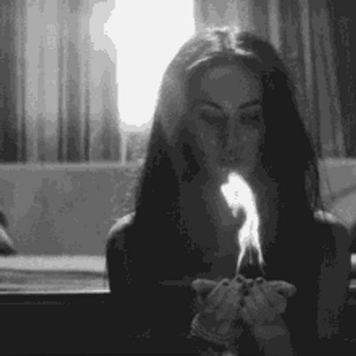 Black And White Megan Fox Holding Flame GIF