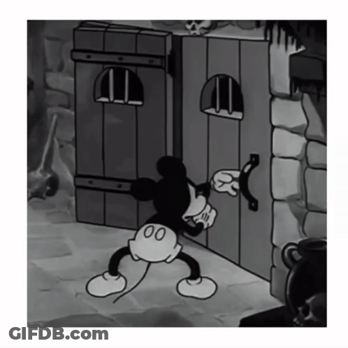 Black And White Mickey Mouse Standing Next To Door GIF