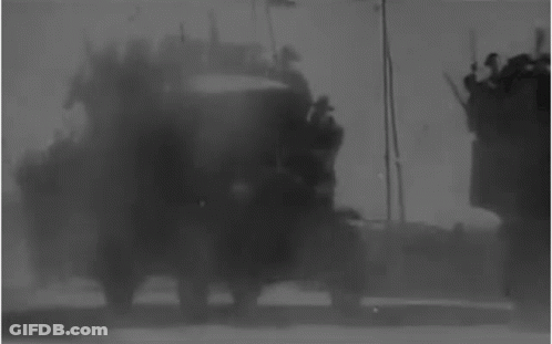 Black And White Military Vehicle On Dirt Road GIF